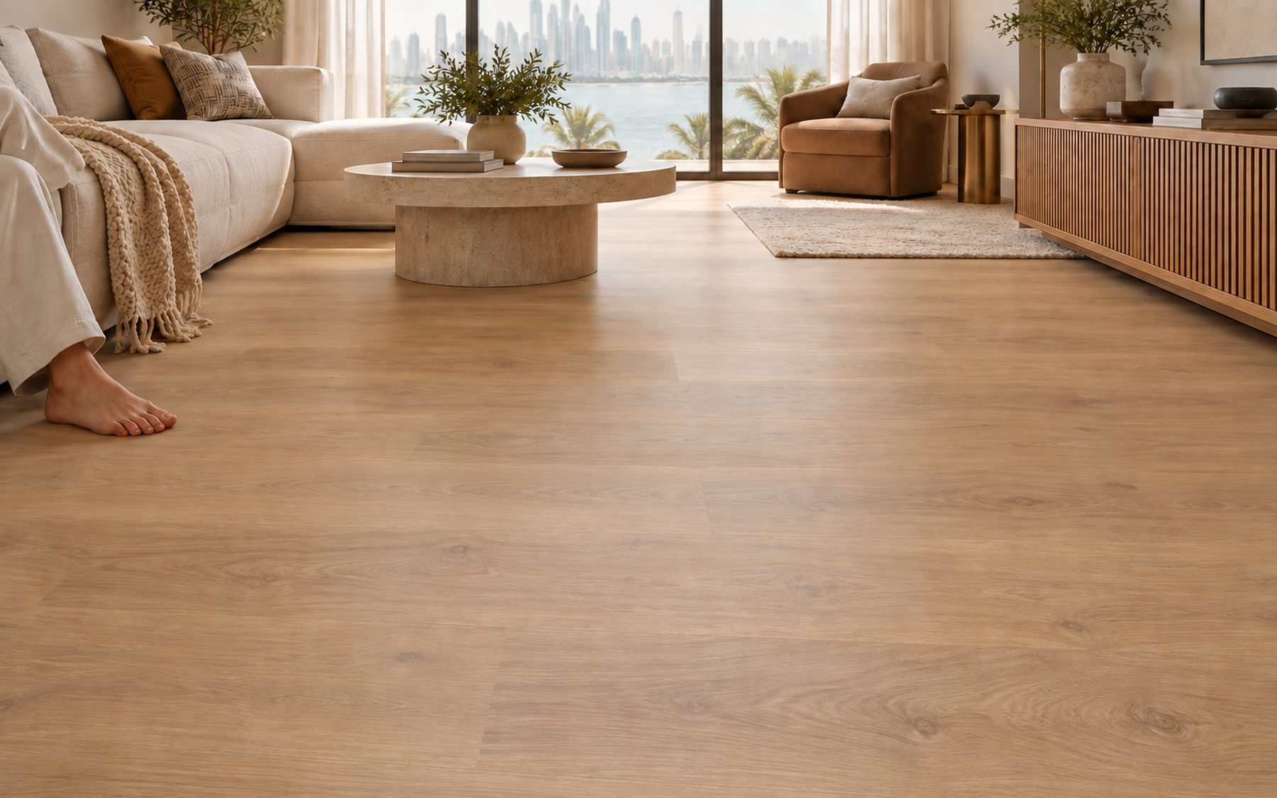 Light straight-plank flooring beside a soft rug, with a bare foot resting on the floor.